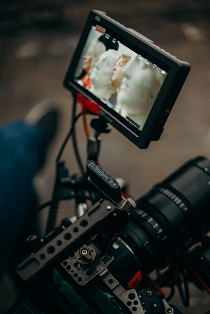 Close-up of a professional video camera setup with a mounted display for filming.